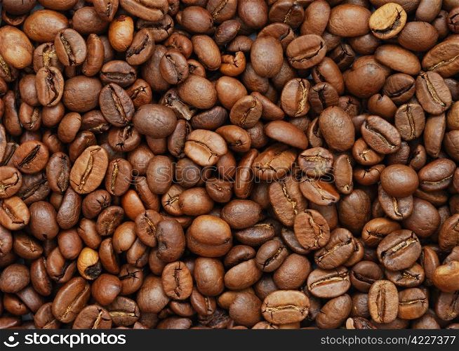 The heap of coffee beans, top view. Coffee beans