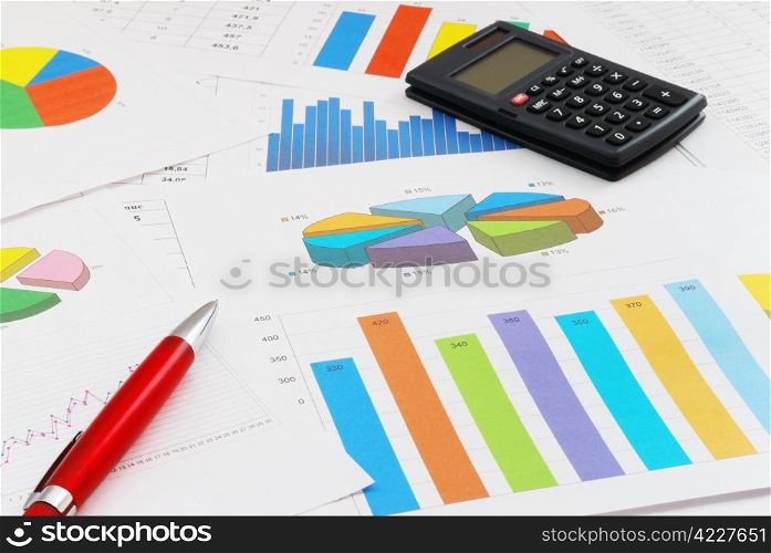 The heap of finance documents with a red pen and calculator. Finance documents