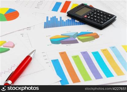 The heap of finance documents with a red pen and calculator. Finance documents
