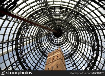 The high, steel-framed, conical-shaped, glass ceiling of a shopping centre
