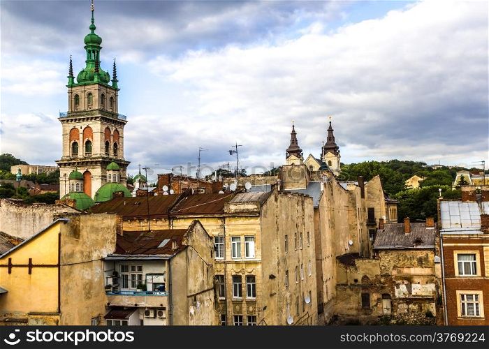 The high tower of The Assumption church among old roofs, Lviv, Ukraine.