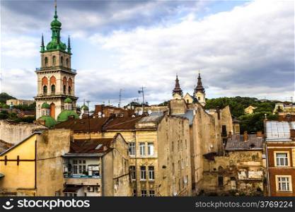 The high tower of The Assumption church among old roofs, Lviv, Ukraine.