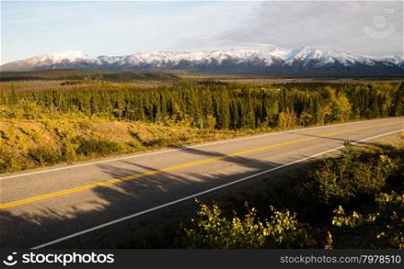The highway cuts past the last tundra before turning into the mountains