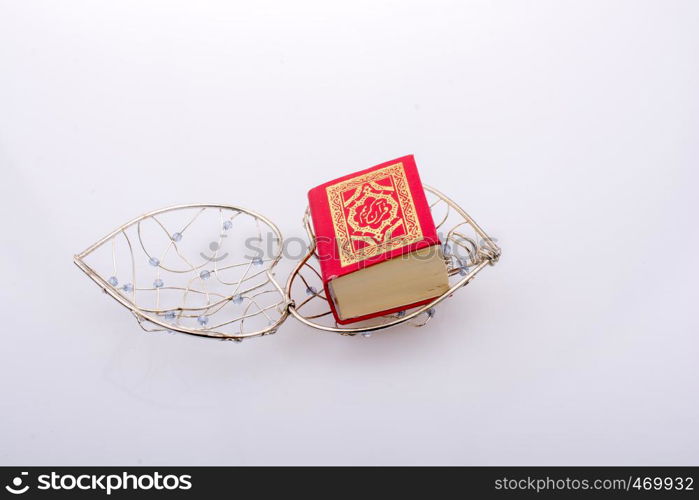 The Holy Quran in mini size in a heart shaped cage