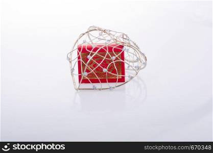 The Holy Quran in mini size in a heart shaped cage