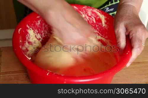 The hostess knead dough, prepare for some cake