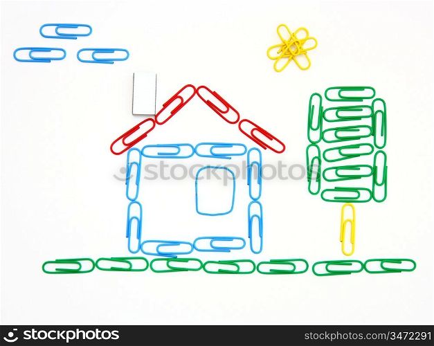 The house and tree from color paper clips on a white background with clouds and the sun