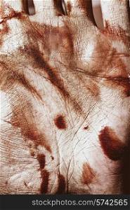 The human skin in gold paint and blood