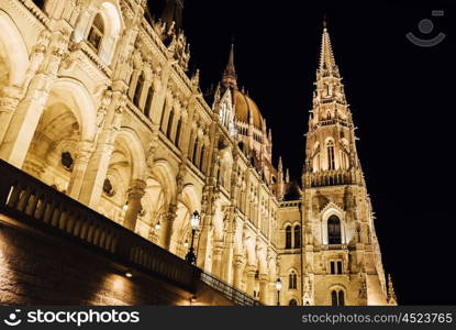 The Hungarian Parliament in Budapest on the Danube in the night lights of the street lamps