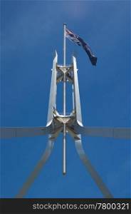 the iconic australian flag on top of parliament house canberra. australian flag