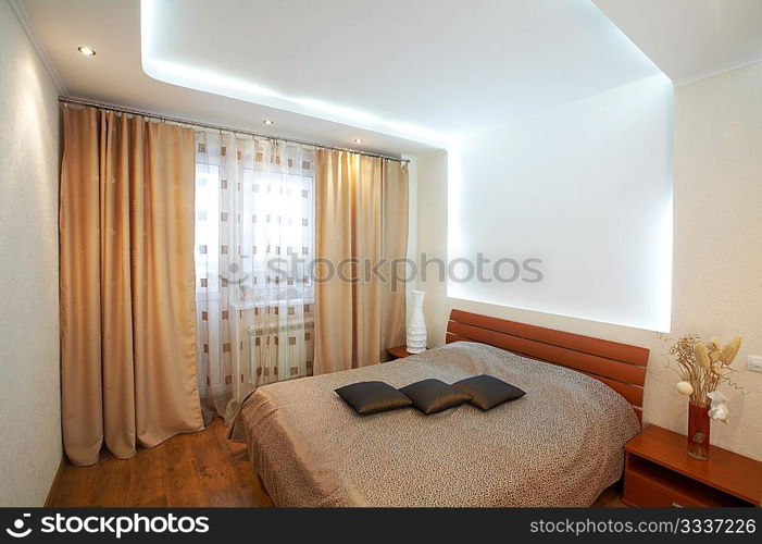 The image of a bedroom with original execution of a ceiling