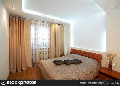 The image of a bedroom with original execution of a ceiling