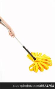 The image of a yellow mop in a hand, isolated. Washing of floors