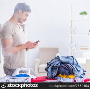 The inattentive husband burning clothing while ironing. Inattentive husband burning clothing while ironing