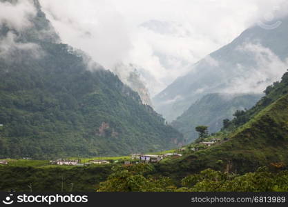 The indian village at himalayan mountain with the morning fog