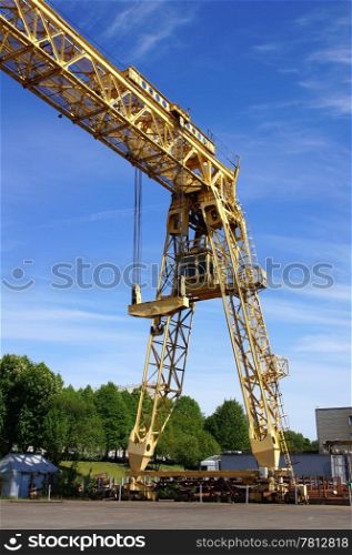 The industrial crane on a background of the blue sky