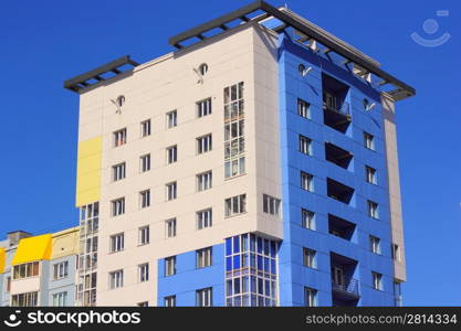 The inhabited high house against the blue sky