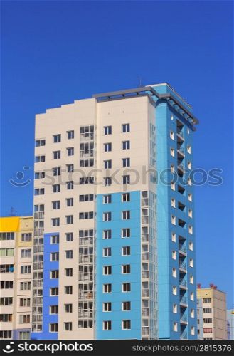 The inhabited high house against the blue sky
