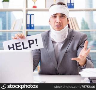 The injured businessman working in the office. Injured businessman working in the office