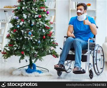 The injured disabled man celebrating christmas at home. Injured disabled man celebrating christmas at home