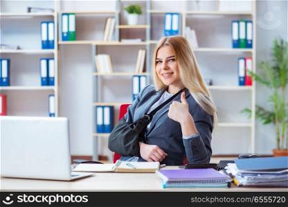 The injured female employee working in the office. Injured female employee working in the office
