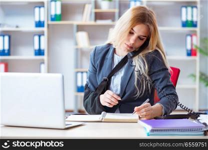 The injured female employee working in the office. Injured female employee working in the office