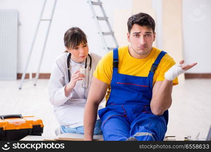 The injured worker being assisted by doctor. Injured worker being assisted by doctor