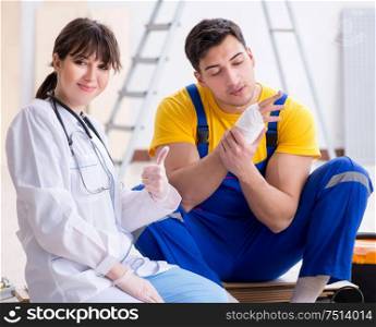 The injured worker being assisted by doctor. Injured worker being assisted by doctor