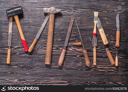 The inscription MAN is written by work tools. The word MAN is made up of a work tools.. The inscription MAN is written by work tools. The word MAN is made up of a work tools