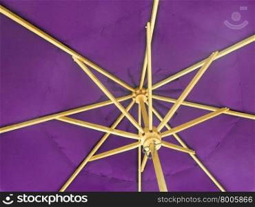 The inside of an open purple umbrella