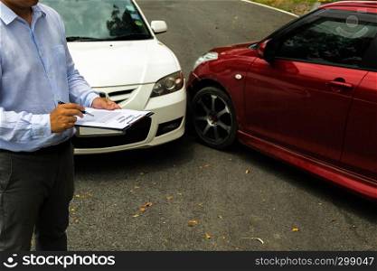 The insurance agent examining car after accident on the road. Insurance claim concept .