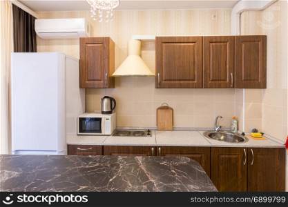 The interior of a modern budget kitchen in a newly built apartment