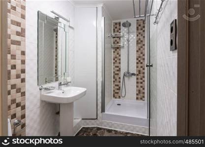 The interior of a small bathroom with shower