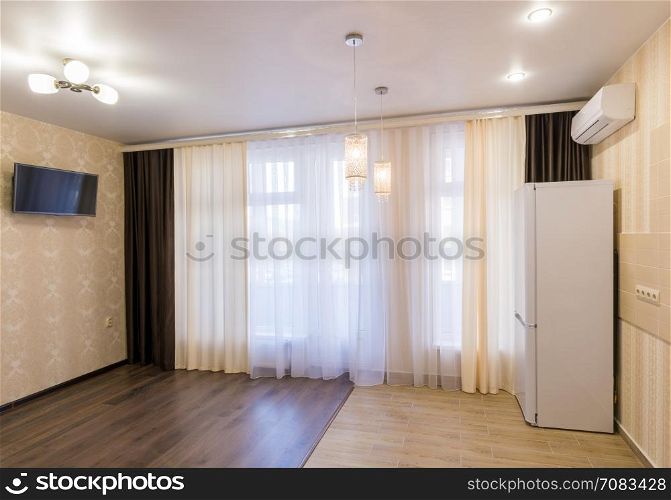 The interior of a small room with kitchen, renovated, unfurnished