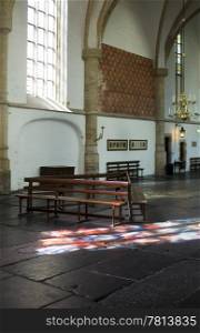 The interior of the Bavo Protestant Church in Haarlem, the Netherlands, with light cast through a stained window on the church floor