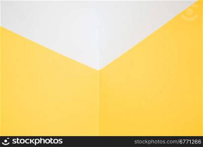 The interior of the room. Corner, a combination of two yellow walls and white ceiling.Horizontal view.
