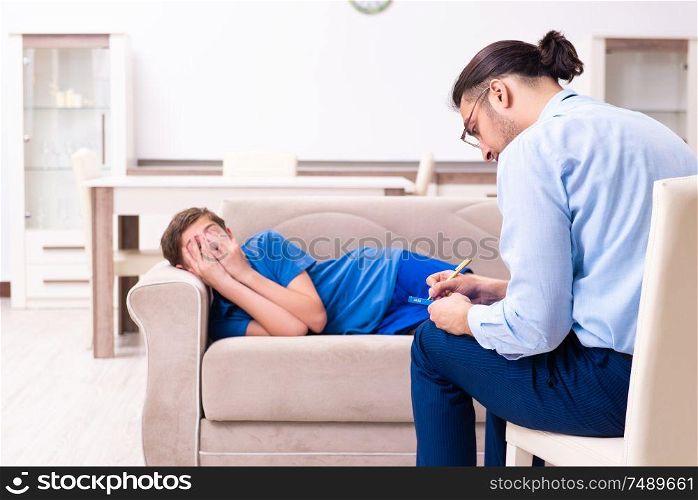 The internet addicted boy visiting male doctor. Internet addicted boy visiting male doctor