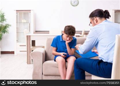 The internet addicted boy visiting male doctor. Internet addicted boy visiting male doctor