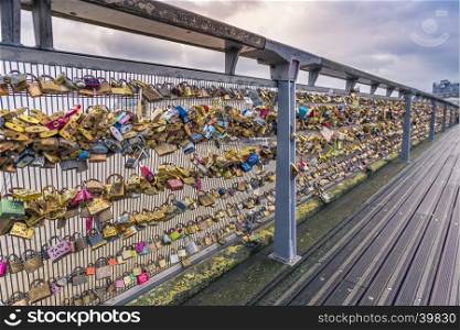 The iron balustrade of the Passerelle Leopold-Sedar-Senghor in Paris, France, filled with locks by tourists to symbolize love and commitment.