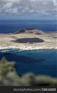 The Isla Graciosa with the village of Caleta del Sebothe from the Mirador del Rio viewpoint on the Island of Lanzarote on the Canary Islands of Spain in the Atlantic Ocean. on the Island of Lanzarote on the Canary Islands of Spain in the Atlantic Ocean.&#xA;