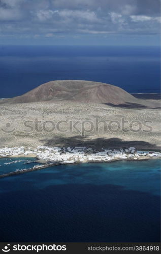 The Isla Graciosa with the village of Caleta del Sebothe from the Mirador del Rio viewpoint on the Island of Lanzarote on the Canary Islands of Spain in the Atlantic Ocean. on the Island of Lanzarote on the Canary Islands of Spain in the Atlantic Ocean.&#xA;