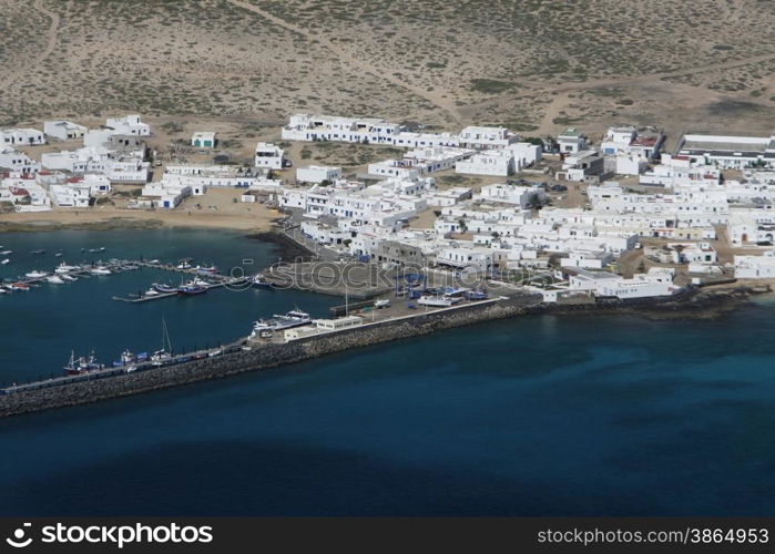 The Isla Graciosa with the village of Caleta del Sebothe from the Mirador del Rio viewpoint on the Island of Lanzarote on the Canary Islands of Spain in the Atlantic Ocean. on the Island of Lanzarote on the Canary Islands of Spain in the Atlantic Ocean.&#xA;