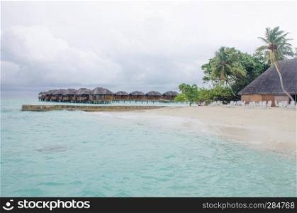 the island of Maldives of the house on Fiholhohi water a landscape the beach with blue water of the Indian Ocean in cloudy day