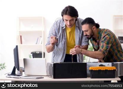 The it engineers working on hardware issue. IT engineers working on hardware issue