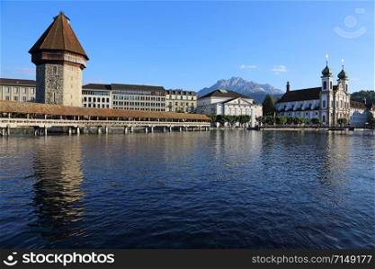 The Kapellbrucke (Chapel Bridge) is a covered wooden bridge crossing the Reuss River, located in the city of Lucerne, Switzerland.. The Chapel Bridge at Dusk