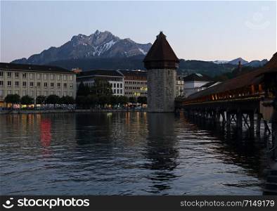 The Kapellbrucke (Chapel Bridge) is a covered wooden bridge crossing the Reuss River, located in the city of Lucerne, Switzerland.. The Chapel Bridge at Sundown