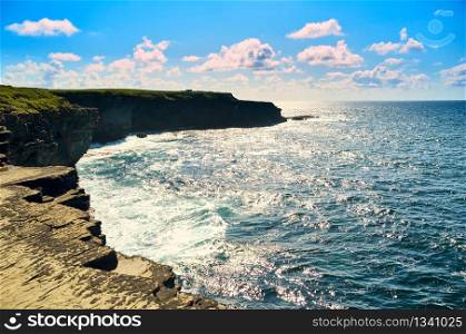The Kilkee Cliff walk is a scenic 2 to 3 hour 8km moderate loop walk along the Kilkee Cliffs starting at the Diamond Rocks Cafe , Pollock Holes car park.. Cliffs of Kilkee in Ireland county Clare. Ocean view, Tourist destination.
