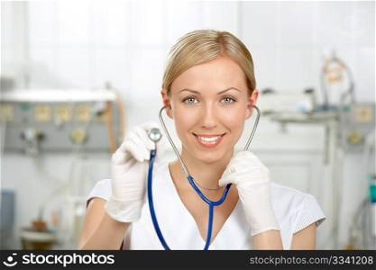 The kind doctor stretches a stethoscope forward against a hospital interior