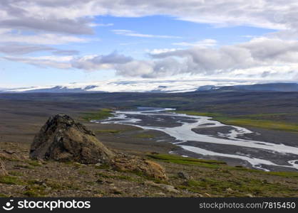 The kjolur Highland landscape with a clear view on the Hofsjokull glacier, and the icy river, flowing through the volcanic ash landscape