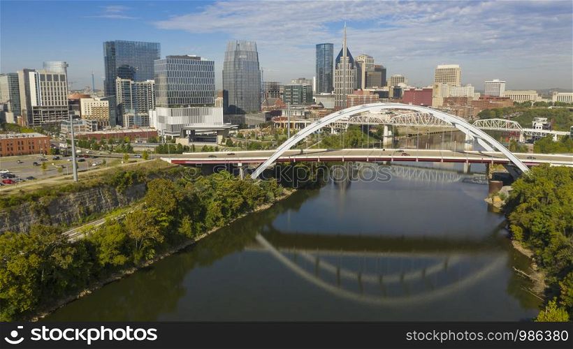 The Korean Veterans Memorial Bridge reflects in the calm Cumberland River early morning in Nashville TN